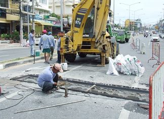 Workers from Pattaya’s Engineering Department repair the sunken drain in Jomtien.